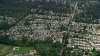5K stock footage aerial video flying by suburban homes around a pond, Brier, Washington Aerial Stock Footage | AX46_014