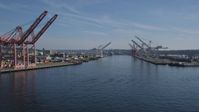 5K stock footage aerial video flyby cargo cranes lining the waterway at Harbor Island, Seattle, Washington Aerial Stock Footage | AX47_099