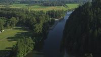 5K stock footage aerial video fly over a bridge on the Snoqualmie River to approach a second bridge in Carnation, Washington Aerial Stock Footage | AX48_032