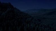 4K day for night color corrected aerial footage of flying over wooded mountain slope toward a clear cut area, King County, Washington Aerial Stock Footage | AX48_054_DFN