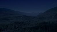 4K day for night color corrected aerial footage of a forest and a narrow road through evergreen trees in King County, Washington Aerial Stock Footage | AX48_057_DFN