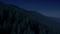 4K day for night color corrected aerial footage of mountain slopes covered with evergreen trees in the Cascade Range, Washington Aerial Stock Footage | AX48_060_DFN