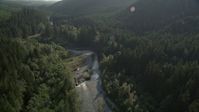 5K stock footage aerial video of flying over a river running through an evergreen forest in King County, Washington Aerial Stock Footage | AX48_070