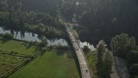 5K stock footage aerial video of tracking a truck crossing a bridge spanning the Snoqualmie River, Carnation, Washington Aerial Stock Footage | AX49_020