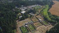 5K stock footage aerial video of flying by fields and the Oregon National Primate Research Center, Hillsboro Aerial Stock Footage | AX53_002