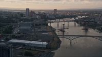5K aerial  video tilt from Willamette River, reveal bridges and Downtown Portland, Oregon, sunset Aerial Stock Footage | AX54_054