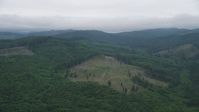 5K stock footage aerial video approach logging area in an evergreen forest in Clatsop County, Oregon Aerial Stock Footage | AX56_041