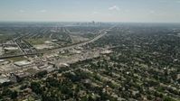 5K stock footage aerial video fly over Gentilly to approach stores by the I-10, with Downtown New Orleans in the background, Louisiana Aerial Stock Footage | AX59_001