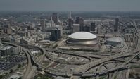 5K stock footage aerial video fly over freeway interchange to approach Superdome, Downtown New Orleans skyscrapers in Louisiana Aerial Stock Footage | AX59_040