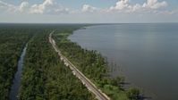 5K stock footage aerial video of railroad tracks through swampland on the lakeshore in La Place, Louisiana Aerial Stock Footage | AX60_009