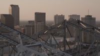 5K stock footage aerial video fly over Crescent City Connection, and focus on skyscrapers, Downtown New Orleans, Louisiana, sunset Aerial Stock Footage | AX61_025