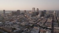 5K stock footage aerial video flyby skyscrapers and approach the Plaza Tower at sunset in Downtown New Orleans, Louisiana Aerial Stock Footage | AX61_026