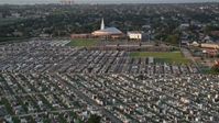 5K stock footage aerial video fly over Greenwood Cemetery toward First Baptist New Orleans Church at sunset, Louisiana Aerial Stock Footage | AX61_032