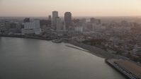 5K stock footage aerial video of Downtown New Orleans skyscrapers at sunset, seen from the Mississippi River, Louisiana Aerial Stock Footage | AX61_051
