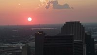 5K stock footage aerial video of the setting sun behind Plaza Tower and Downtown New Orleans, Louisiana Aerial Stock Footage | AX61_071