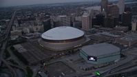 5K stock footage aerial video orbit the Superdome and New Orleans Arena at sunset, Downtown New Orleans, Louisiana Aerial Stock Footage | AX61_076