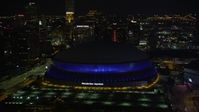 5K stock footage aerial video approach Superdome and skyscrapers at night, Downtown New Orleans, Louisiana Aerial Stock Footage | AX62_005