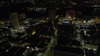 5K stock footage aerial video follow Poydras Street to hotels in Downtown New Orleans at night, Louisiana Aerial Stock Footage | AX62_008