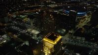 5K stock footage aerial video fly over skyscrapers and approach the Superdome in Downtown New Orleans at night, Louisiana Aerial Stock Footage | AX62_011