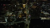 5K stock footage aerial video follow Poydras Street through Downtown New Orleans at night, Louisiana Aerial Stock Footage | AX62_013