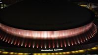 5K stock footage aerial video of Mercedes-Benz Superdome with orange lighting at night, Downtown New Orleans, Louisiana Aerial Stock Footage | AX63_023