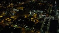 5K stock footage aerial video of Downtown New Orleans buildings and streets at night, Louisiana Aerial Stock Footage | AX63_032