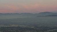 5K stock footage aerial video of San Gabriel Mountains from across the San Fernando Valley, Los Angeles, California, twilight Aerial Stock Footage | AX64_0159