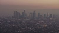 5K stock footage aerial video of the Downtown Los Angeles skyline in haze, California, twilight Aerial Stock Footage | AX64_0176