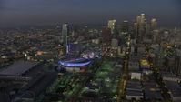 5K stock footage aerial video fly away from Staples Center, Ritz Carlton, and skyscrapers, Downtown Los Angeles, California, twilight Aerial Stock Footage | AX64_0220