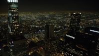 5K stock footage aerial video fly between skyscrapers in Downtown Los Angeles, California, night Aerial Stock Footage | AX64_0358