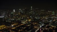 5K stock footage aerial video reverse view of office buildings and Downtown Los Angeles skyscrapers, California, night Aerial Stock Footage | AX64_0360