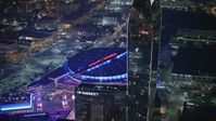 5K stock footage aerial video of passing Ritz-Carlton Hotel to focus on Staples Center, Downtown Los Angeles, California, night Aerial Stock Footage | AX64_0406