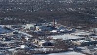 4.8K stock footage aerial video factory with smoke stacks in snow, Farmingdale, New York Aerial Stock Footage | AX66_0004
