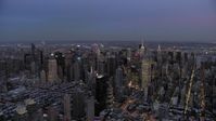4.8K stock footage aerial video of passing by Midtown skyscrapers in winter, New York City, twilight Aerial Stock Footage | AX66_0345