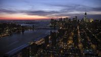 4.8K stock footage aerial video of Manhattan and Brooklyn Bridges, Lower East Side apartments in winter, New York City, twilight Aerial Stock Footage | AX66_0395