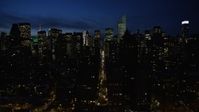 4.8K stock footage aerial video of Midtown Manhattan's tall skyscrapers and city streets, New York City, night Aerial Stock Footage | AX66_0421
