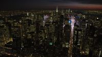 4.8K stock footage aerial video of Midtown Manhattan skyscrapers around Times Square, New York City, night Aerial Stock Footage | AX66_0436