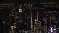 4.8K aerial video view follow 6th Street toward Empire State Building in Midtown Manhattan at night, New York City, New York Aerial Stock Footage | AX67_0019