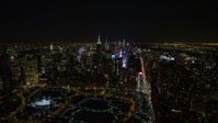 4.8K aerial video view of Times Square, skyscrapers, and Columbus Circle in Midtown Manhattan at night in winter, New York City, New York Aerial Stock Footage | AX67_0026