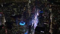 4.8K aerial video view tilt from Times Square to reveal Empire State Building at night, Midtown Manhattan, New York City, New York Aerial Stock Footage | AX67_0036