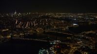 4.8K aerial video view of flying by Brooklyn Bridge, Manhattan Bridge at night, New York Aerial Stock Footage | AX67_0100