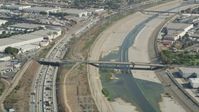 4.8K stock footage aerial video of light Traffic on I-710 by between warehouse buildings and the Los Angeles River in Vernon, Los Angeles, California Aerial Stock Footage | AX68_037