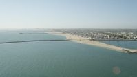 4.8K stock footage aerial video approach the breakwater, pier, beach and coastal neighborhoods in Seal Beach, California Aerial Stock Footage | AX68_121