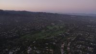 4.8K stock footage aerial video approach a golf course and mansions at sunset in Pacific Palisades, California Aerial Stock Footage | AX69_048