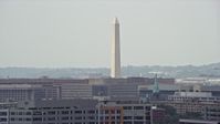 4.8K stock footage aerial video of the Washington Monument seen from smoke stacks in Washington DC Aerial Stock Footage | AX74_060E