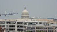 4.8K stock footage aerial video of United States Capitol Dome seen above office buildings in Washington DC Aerial Stock Footage | AX74_089E