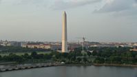 4.8K stock footage aerial video of Washington Monument seen from Tidal Basin, Washington D.C., sunset Aerial Stock Footage | AX76_061