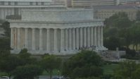 4.8K stock footage aerial video flying by Lincoln Memorial with tourists on the steps, Washington D.C., sunset Aerial Stock Footage | AX76_067E