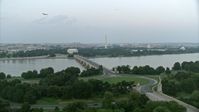 4.8K stock footage aerial video of Lincoln Memorial, Washington Monument seen from Arlington Memorial Bridge, Washington, D.C., twilight Aerial Stock Footage | AX76_129