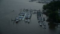 4.8K stock footage aerial video flying by docked boats at a marina on the Potomac River, Washington, D.C., twilight Aerial Stock Footage | AX76_174